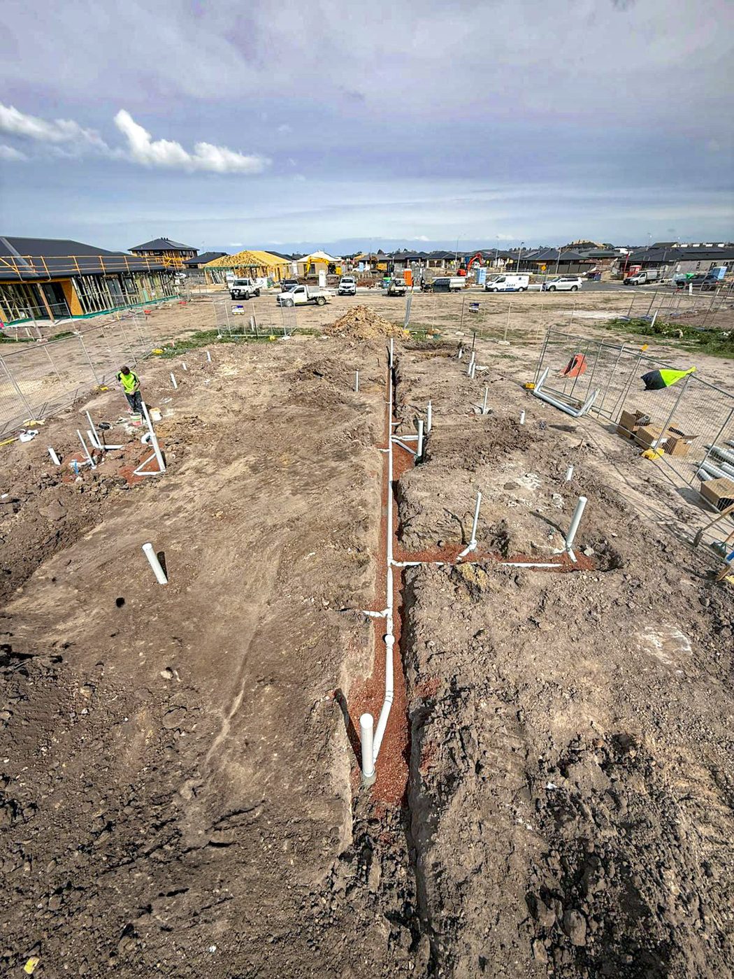 Drainage trench works across a residential property.