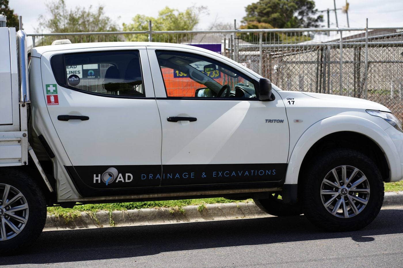 A branded Hoad Drainage & Excavations vehicle parked on site.